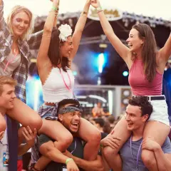 Radosna ekipa na jednym z corocznych festiwali w Polsce. Dziewczyny siedzą na barana, bawiąc się przy muzyce.