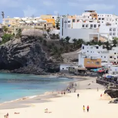 Piękna plaża i białe domy na Fuerteventurze. Idealne miejsce na wakacyjny **fuerteventura plan zwiedzania**.